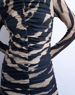 Model wearing Ruched front drop waist maxi dress in large animal print