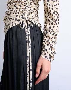 Model wearing Ruched long sleeve top in animal print