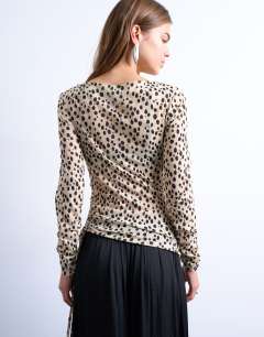 Model wearing Ruched long sleeve top in animal print
