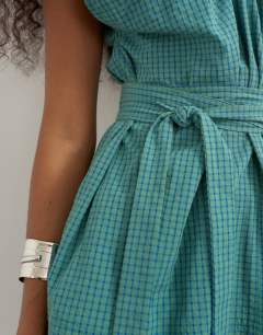 Model wearing Ruched neckline tie detail top in green and blue check