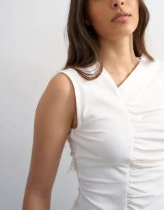Model wearing Ruched seam tank in white