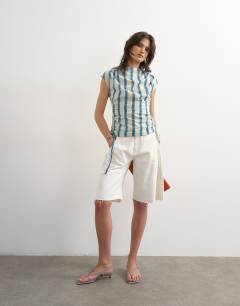 Model wearing Ruched side cap sleeve top in cream stripe