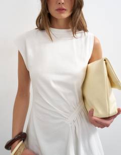 Model wearing Ruched side detail asymmetric top in ivory
