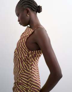 Model wearing Ruched side gathered shoulder midi dress in brown lime stripe