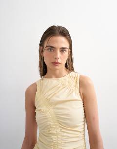 Model wearing Ruched sleeveless midi dress in buttermilk