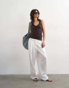 Model wearing Ruched v-neck tank top in dark chocolate