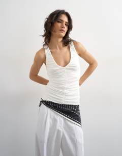 Model wearing Ruched v-neck tank top in ivory
