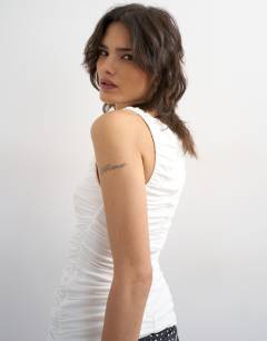 Model wearing Ruched v-neck tank top in ivory