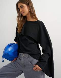 Model wearing Ruffle asymmetric top in black
