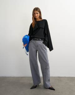 Model wearing Ruffle asymmetric top in black