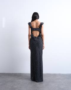 Model wearing Ruffle shoulder amalfi slip dress in black based spot