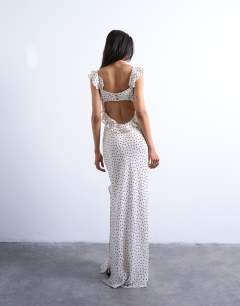 Model wearing Ruffle shoulder amalfi slip dress in mono spot
