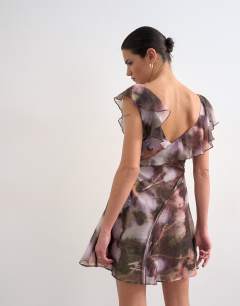 Model wearing Ruffle style mini dress in ghostly floral