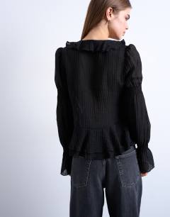 Model wearing Ruffle tie front long sleeve top in black