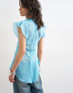 Model wearing Ruffle v neck top in blue