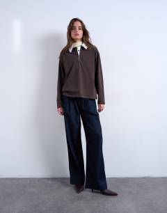 Model wearing Rugby long sleeve polo top in chocolate