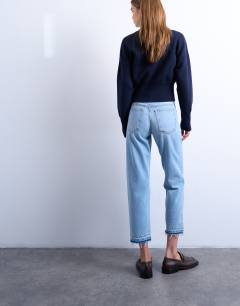 Model wearing Runway mid rise straight cropped jean with let down hem detail in bleach