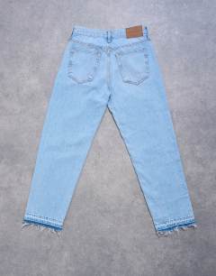 Model wearing Runway mid rise straight cropped jean with let down hem detail in bleach