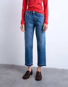 Model wearing Runway mid rise straight cropped jean with let down hem detail in vintage blue