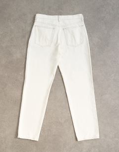 Model wearing Runway mid rise straight jean in bone