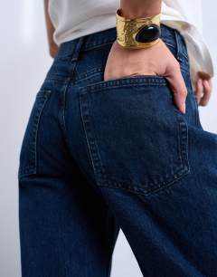 Model wearing Runway mid rise straight jean in navy