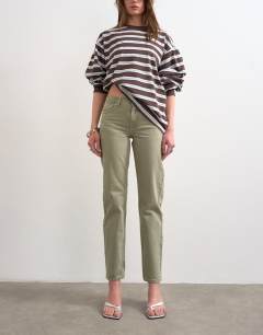 Model wearing Runway mid rise straight jean in washed khaki