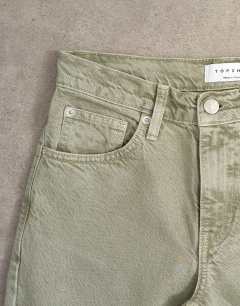 Model wearing Runway mid rise straight jean in washed khaki