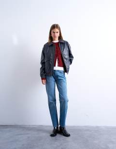Model wearing Runway mid rise straight jeans in mid blue