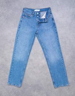 Model wearing Runway mid rise straight jeans in vintage blue