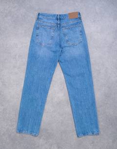 Model wearing Runway mid rise straight jeans in vintage blue