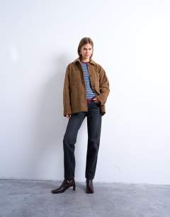 Model wearing Runway mid rise straight jeans in washed black