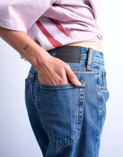 Model wearing Runway straight mid rise jean in mid blue