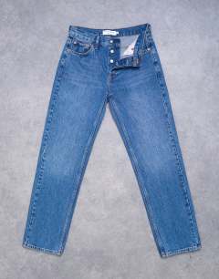Model wearing Runway straight mid rise jean in mid blue