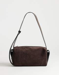 Model wearing Sabrina medium suedette shoulder bag with pockets in chocolate