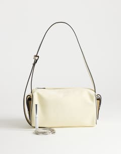 Model wearing Sabrina medium suedette shoulder bag with pockets in cream