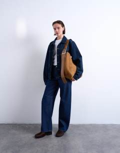 Model wearing Sade premium real suede leather bucket shoulder bag in tan