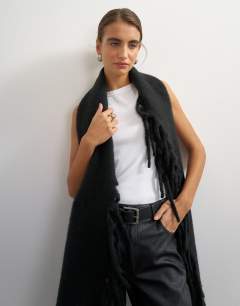 Model wearing Sadie fringing scarf in black