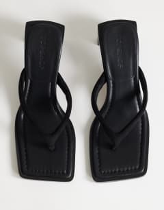 Model wearing Sadie toe thong heel in black