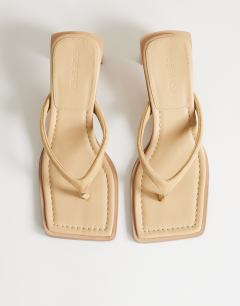 Model wearing Sadie toe thong mid heel in camel