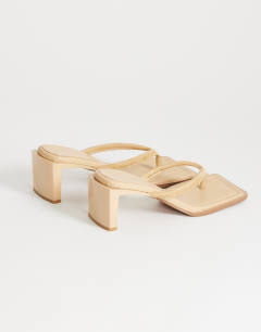 Model wearing Sadie toe thong mid heel in camel