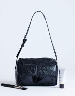 Model wearing Safia front pocket shoulder bag in black