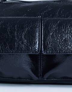 Model wearing Safia front pocket shoulder bag in black