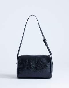 Model wearing Safia front pocket shoulder bag in black