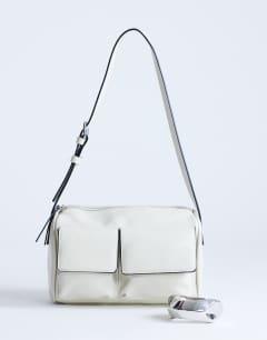 Model wearing Safia front pocket shoulder bag in off white