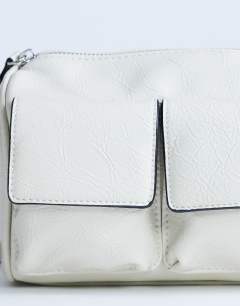 Model wearing Safia front pocket shoulder bag in off white