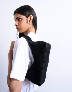 Model wearing Safia real suede shoulder bag in black