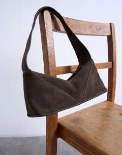 Model wearing Safia real suede shoulder bag in chocolate