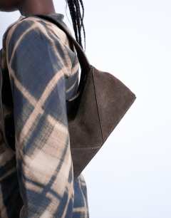 Model wearing Safia real suede shoulder bag in chocolate