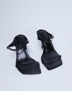 Model wearing Sally 2 part metal high heeled sandal in black