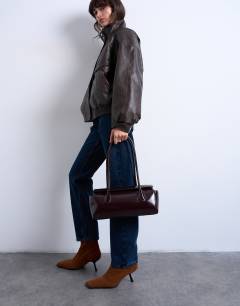 Model wearing Sally folded bag in burgundy